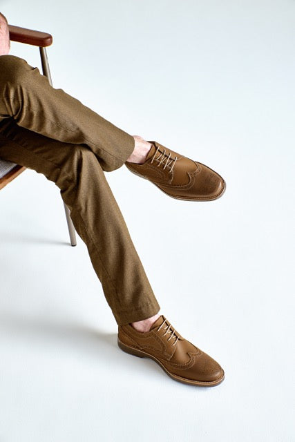Studio lifestyle image of the Artelio Fifth Avenue terracotta leather wingtip derby with brogue detailing