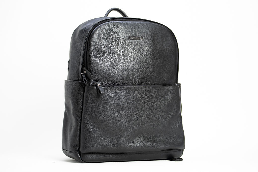 Front angle of the Artelio black leather backpack showing the zippered front pocket and structured shape