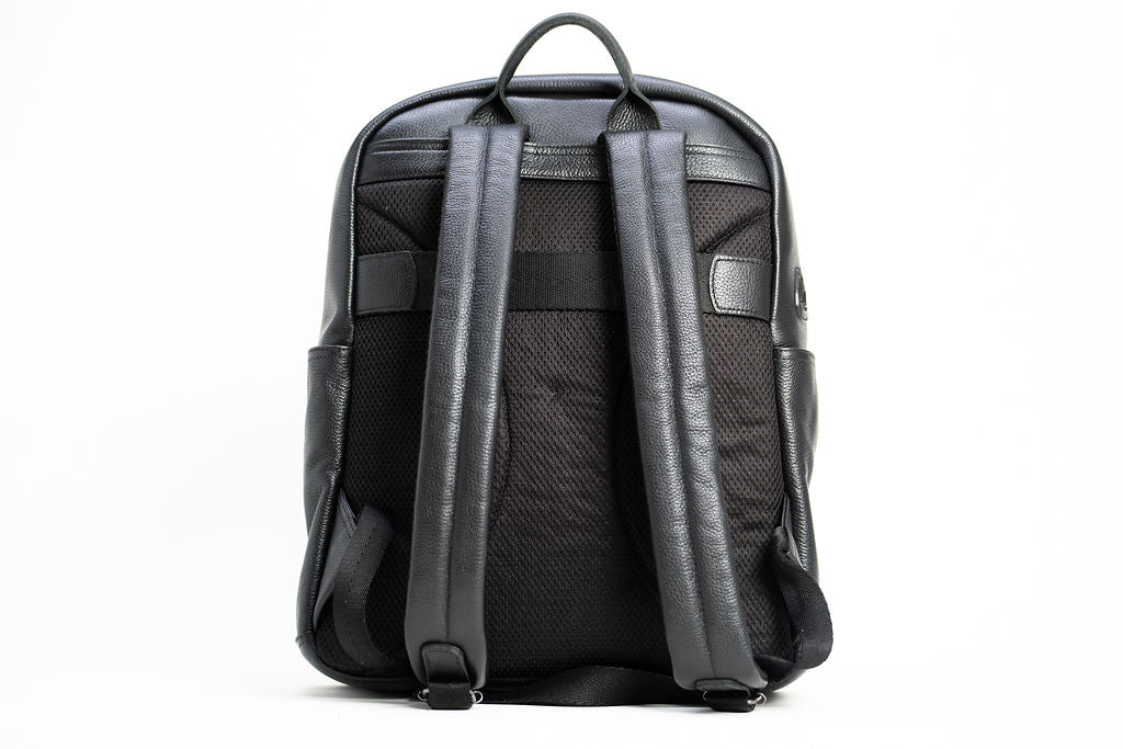 Rear view of the Artelio black leather backpack with padded mesh back panel and adjustable shoulder straps