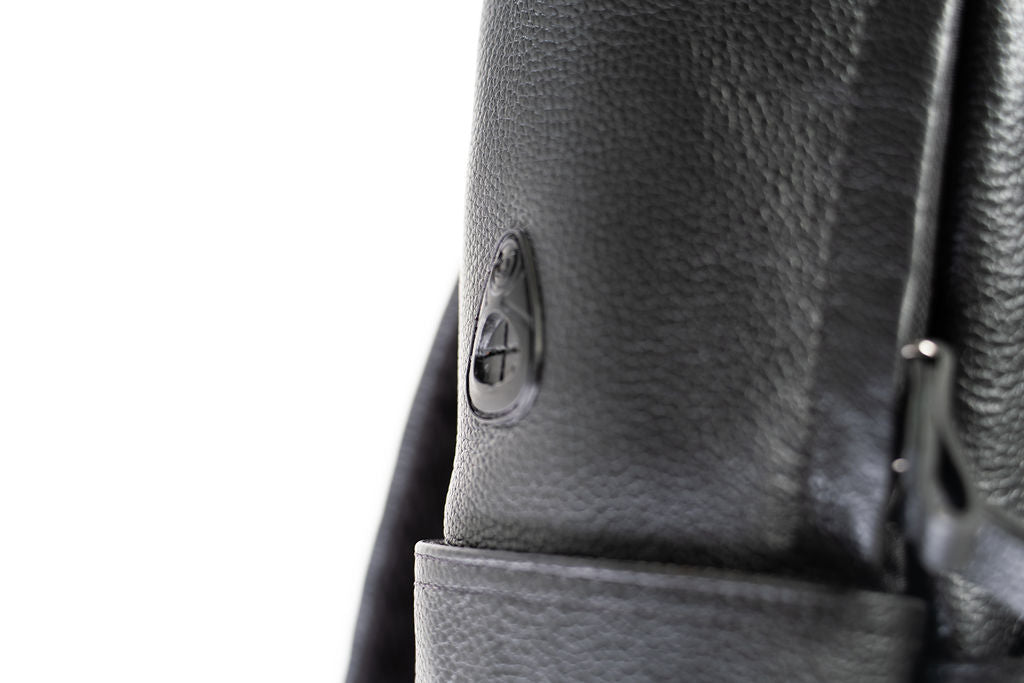 Close-up of the side hardware and pocket on the Artelio black leather backpack
