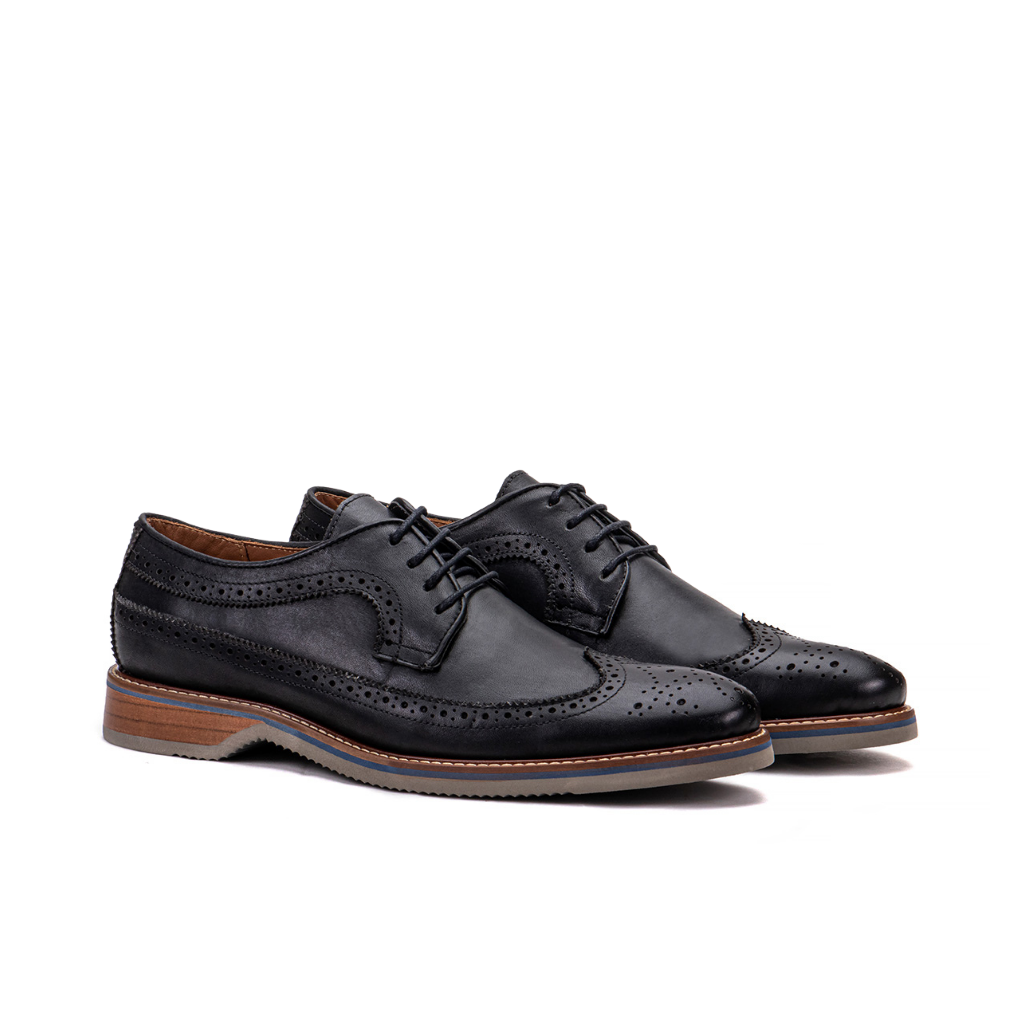Front angle of The Brasilia black leather wingtip brogue derby with layered sole detail