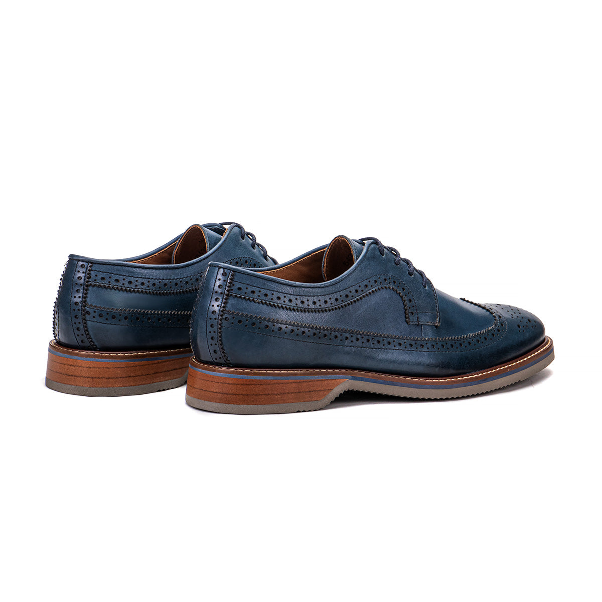 Rear angle of The Brasilia blue leather wingtip brogue derby showing heel and layered sole detail
