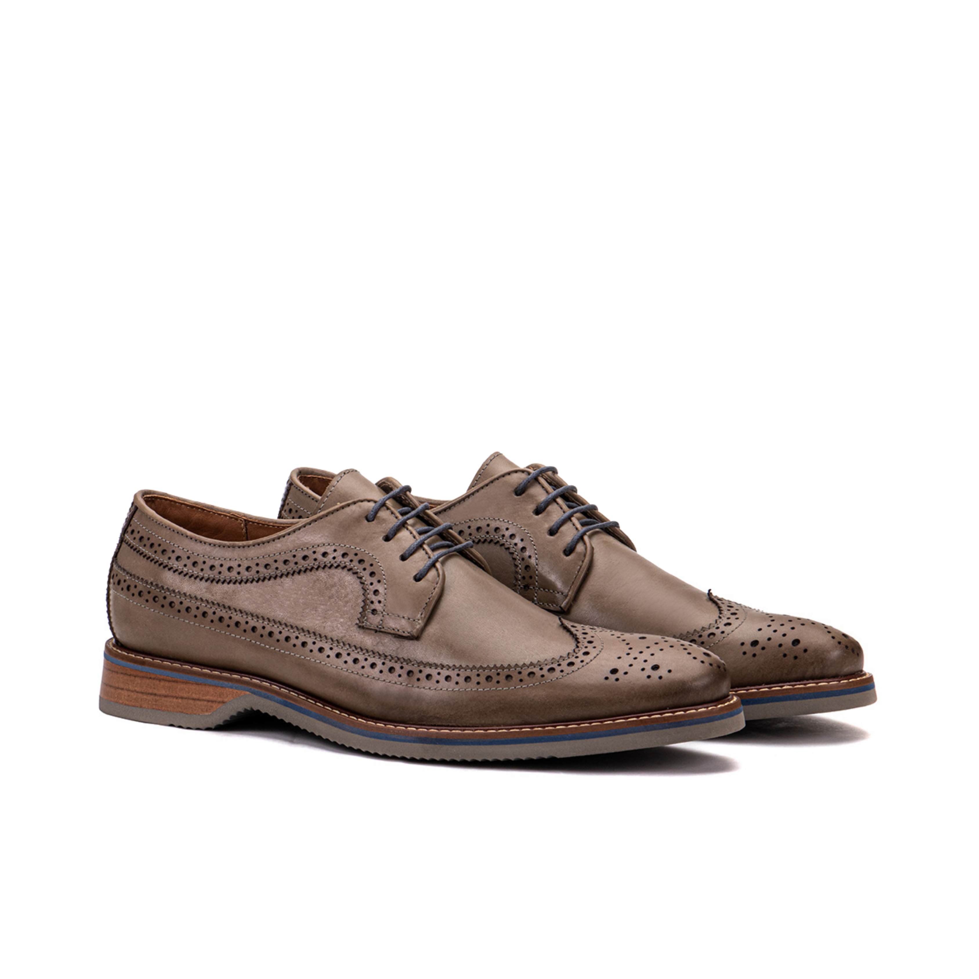 Front angle of The Brasilia foggy gray leather wingtip brogue derby with layered sole detail