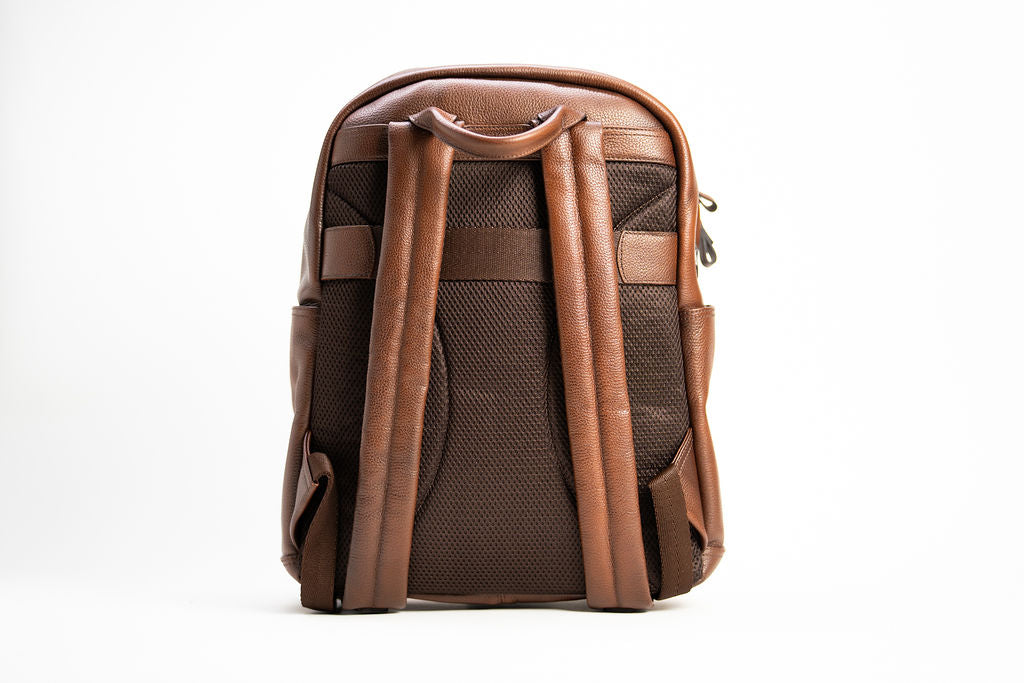 Rear view of the Artelio brown leather backpack with padded mesh back panel and adjustable shoulder straps