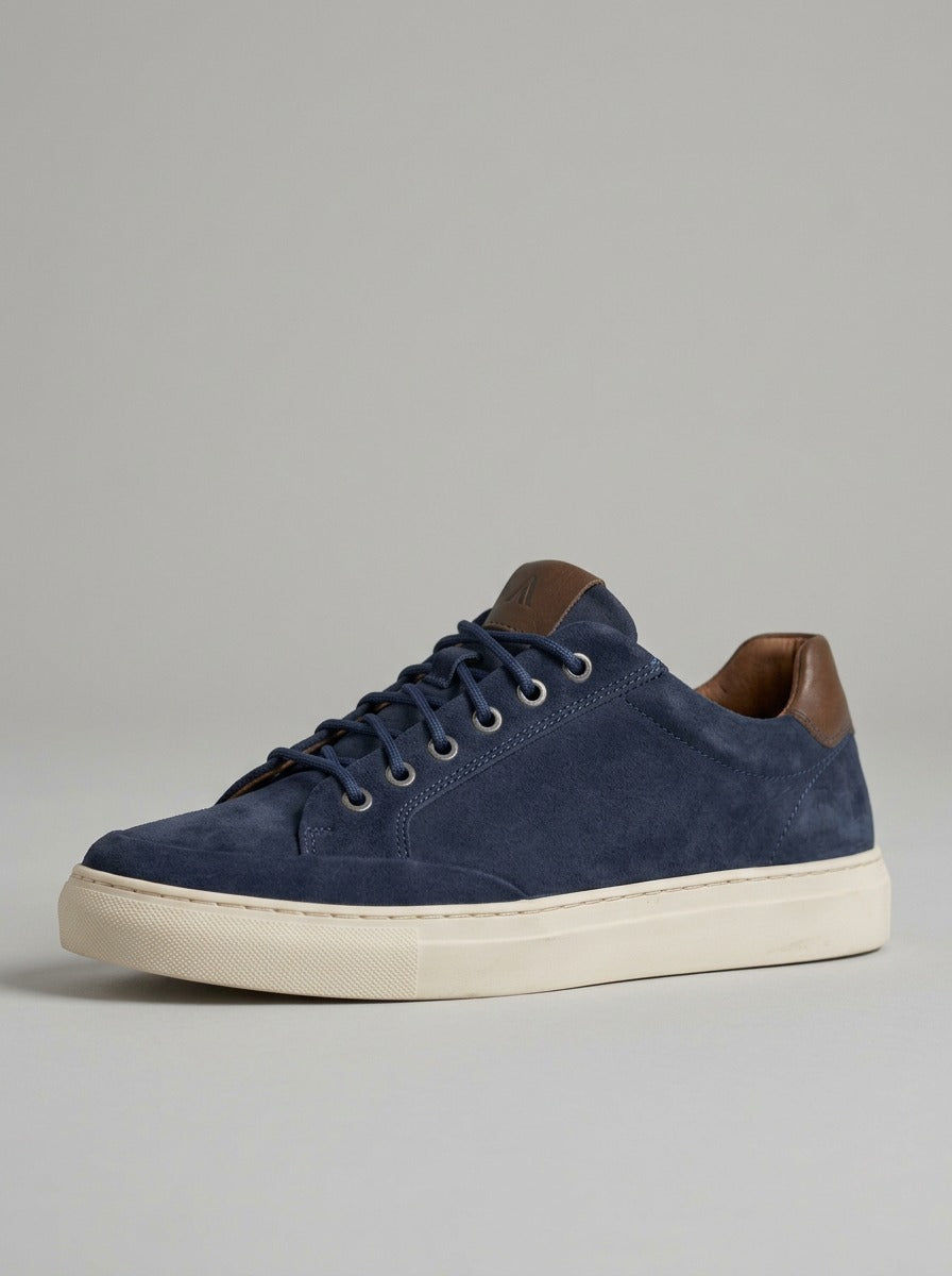 Studio lifestyle image of the Artelio Elasticore navy nubuck sneaker with clean low-top styling