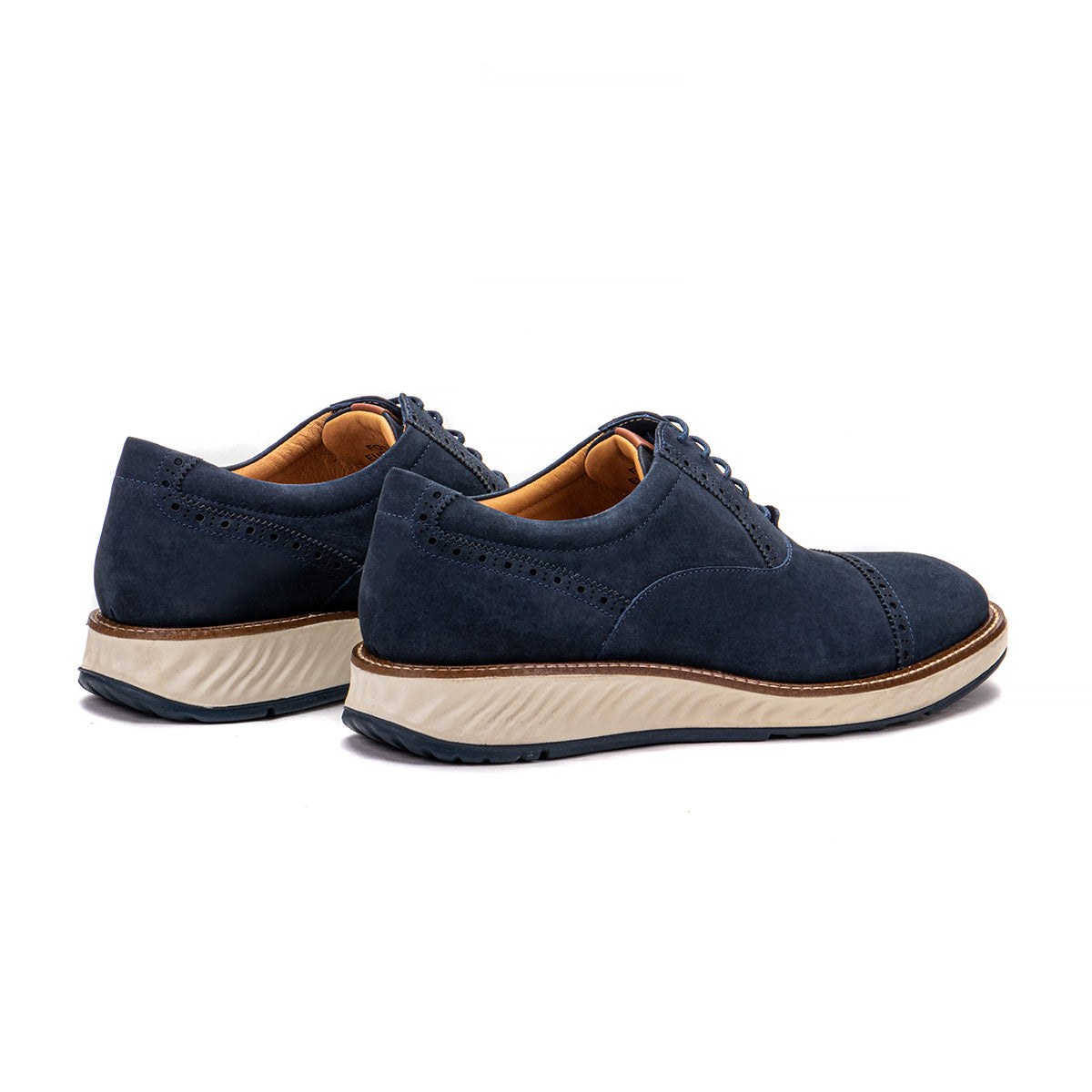 Rear angle of the Artelio Greenville navy blue nubuck cap-toe oxford showing the low-profile heel and white sole
