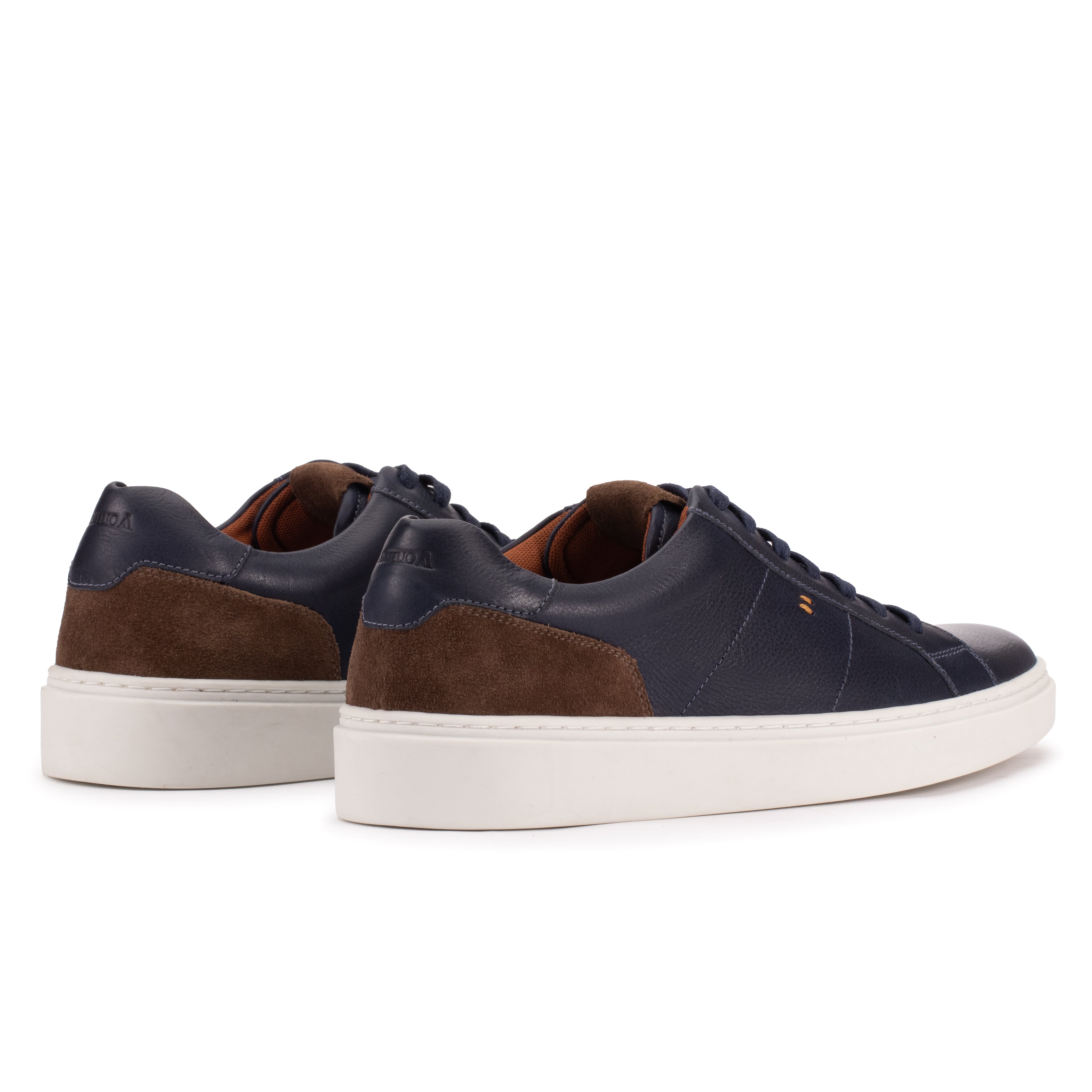 Rear angle of the Artelio Heritage indigo and chocolate leather sneaker showing the suede heel detail