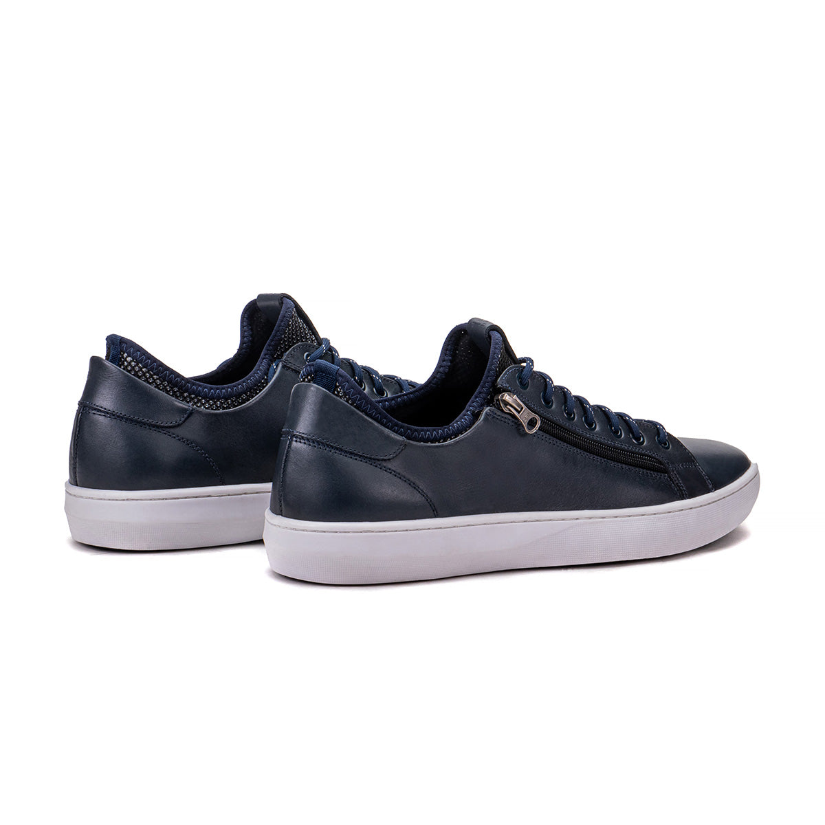 Rear angle of the Artelio Pikes Peak navy leather side-zip sneaker showing the heel and low-top profile