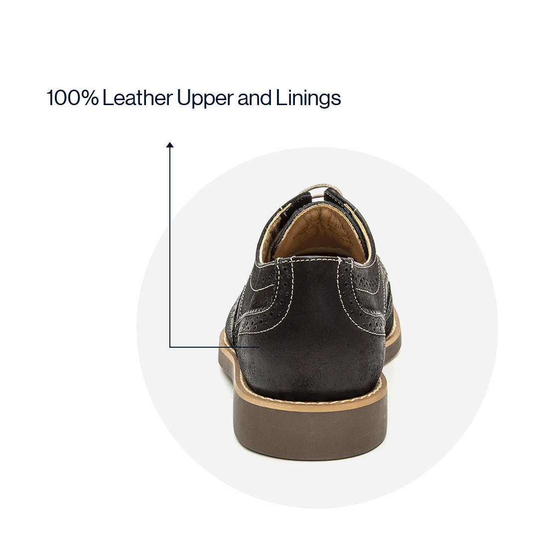 Lifestyle view of the Artelio Santiago midnight black leather wingtip derby styled for dress-casual wear