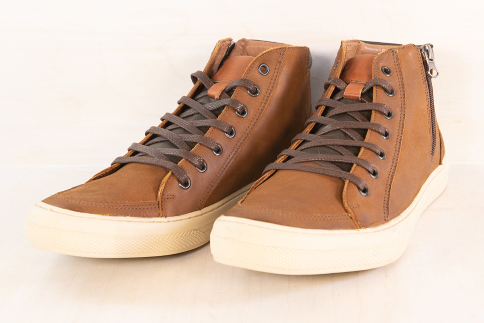Front angle of the Artelio Campinas distressed cognac leather high-top sneaker boot showing the leather upper and roomy toe